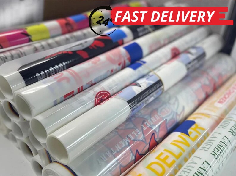 May include: A stack of rolled-up posters with various designs and text, including "MIAMI" and "SUNSET ELEMENTARY". The posters are wrapped in clear plastic. The image also includes a "24h FAST DELIVERY" graphic.