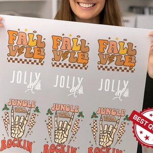 May include: A sheet of printed designs featuring the words "FALL VALE" in orange and brown retro font, "JOLLY", and "JUNGLE ROCKIN" with a skeleton hand graphic. A "BEST QUALITY" sticker is in the bottom right.