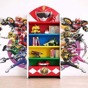 May include: A multi-coloured bookcase with shelves in red, yellow, blue, and green, decorated with Power Rangers and their Zords. The top of the bookcase features a red helmet and a small figurine. Books and toys are on the shelves.
