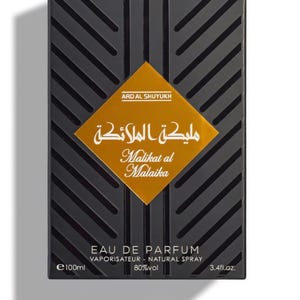 May include: Black rectangular perfume box with diagonal lines and a gold diamond-shaped label. The label features Arabic and English text: "Malikat al Malaika". The box also indicates "EAU DE PARFUM" and 3.4 fl.oz.