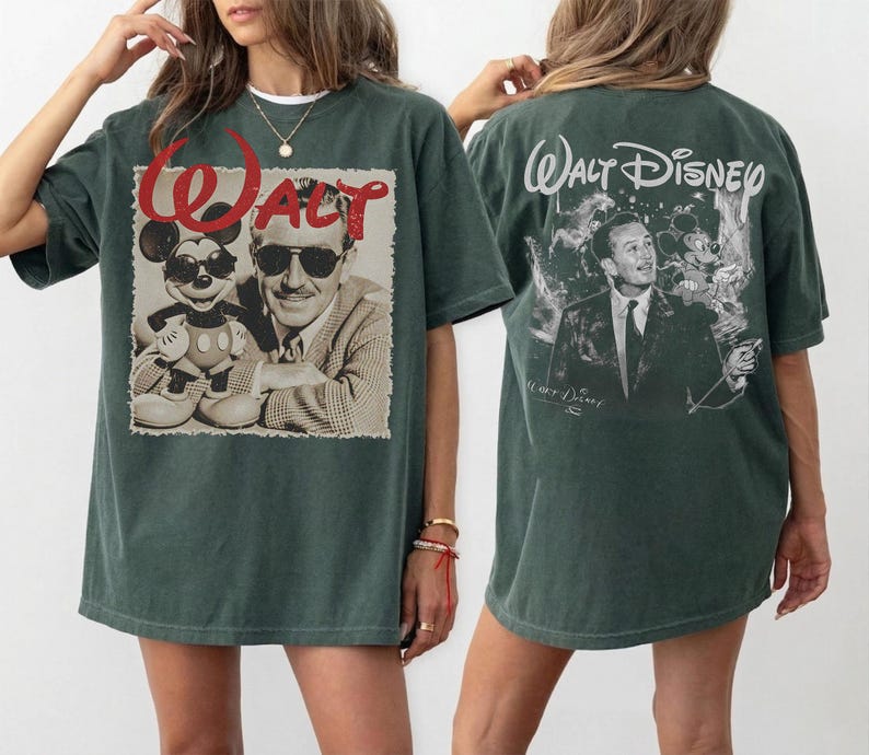 May include: A dark green oversized t-shirt featuring a graphic on the front and back. The front displays a sepia-toned image of Walt Disney and Mickey Mouse wearing sunglasses with the red text Walt. The back shows Walt Disney with Mickey Mouse.