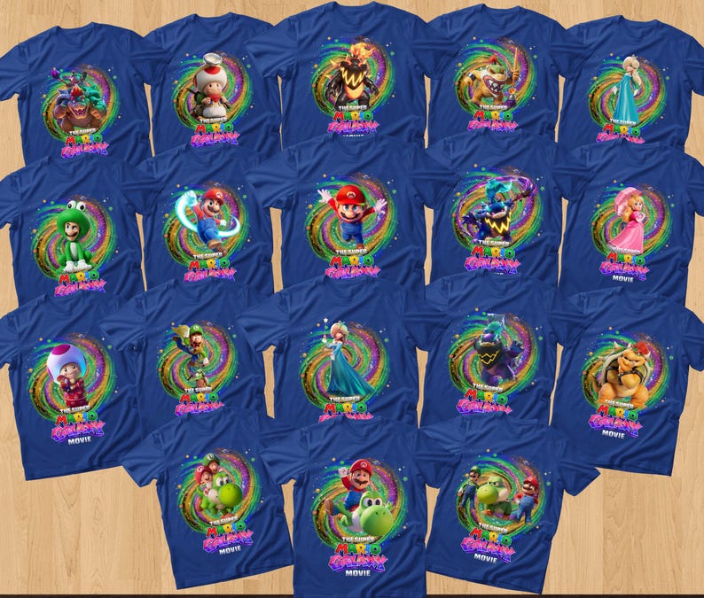 May include: A collection of royal blue t-shirts featuring various characters from The Super Mario Bros. Movie. Each shirt displays a central graphic of a character surrounded by a colorful, swirling cosmic vortex and the text The Super Mario Bros. Movie.