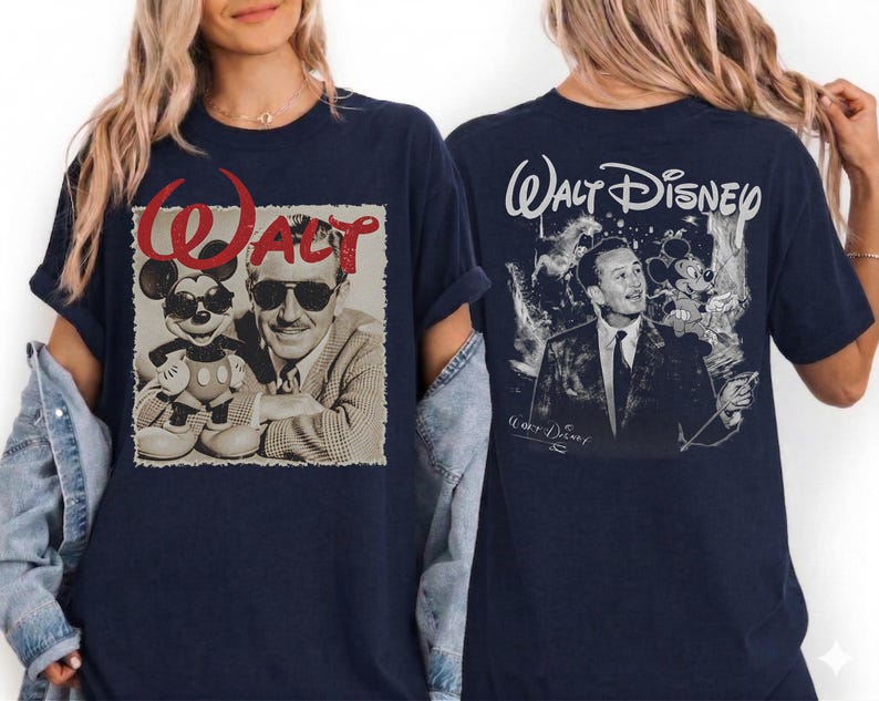 May include: A navy blue t-shirt featuring a front graphic of Walt Disney and Mickey Mouse wearing sunglasses with the red text Walt above them. The back of the shirt displays a black and white illustration of Walt Disney with Mickey Mouse.