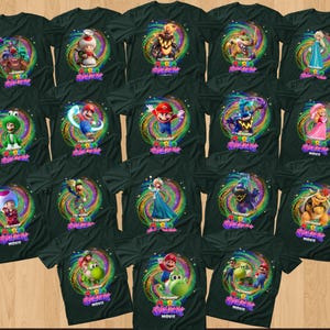 May include: A collection of black t-shirts featuring various characters from The Super Mario Bros. Movie, including Mario, Luigi, Peach, Toad, and Bowser, each set against a vibrant, swirling, multi-colored cosmic background with the movie logo.