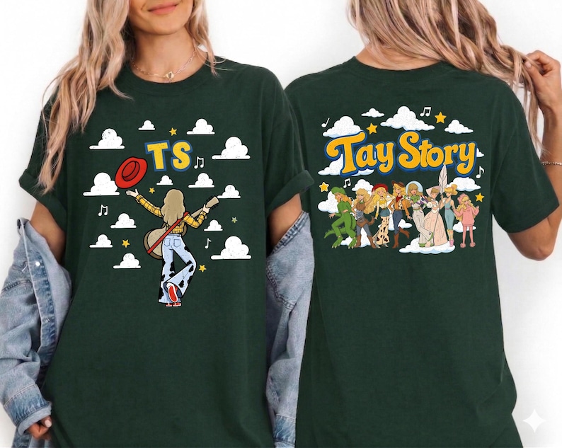 May include: A dark green t-shirt featuring a graphic print. The front shows a figure with a guitar, a red hat, and the text TS. The back displays a group of illustrated figures and the text Tay Story, both set against a background of clouds.