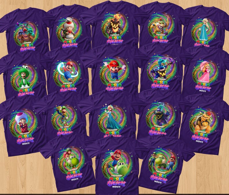 May include: A collection of purple t-shirts featuring various characters from The Super Mario Bros. Movie, including Mario, Luigi, Peach, Toad, and Bowser, each centered within a colorful, swirling cosmic graphic with the movie title text.
