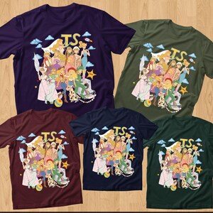 May include: Five short-sleeved crew neck t-shirts in dark purple, olive green, maroon, navy blue, and dark forest green. Each shirt features a central graphic illustration of various animated characters, the letters TS, clouds, a rocket, and a star.