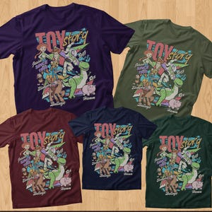 May include: Five short-sleeve t-shirts in purple, olive green, maroon, navy blue, and dark green. Each shirt features a graphic print of Toy Story characters including Jessie, Woody, Buzz Lightyear, Rex, Slinky Dog, Bullseye, and Hamm with text.