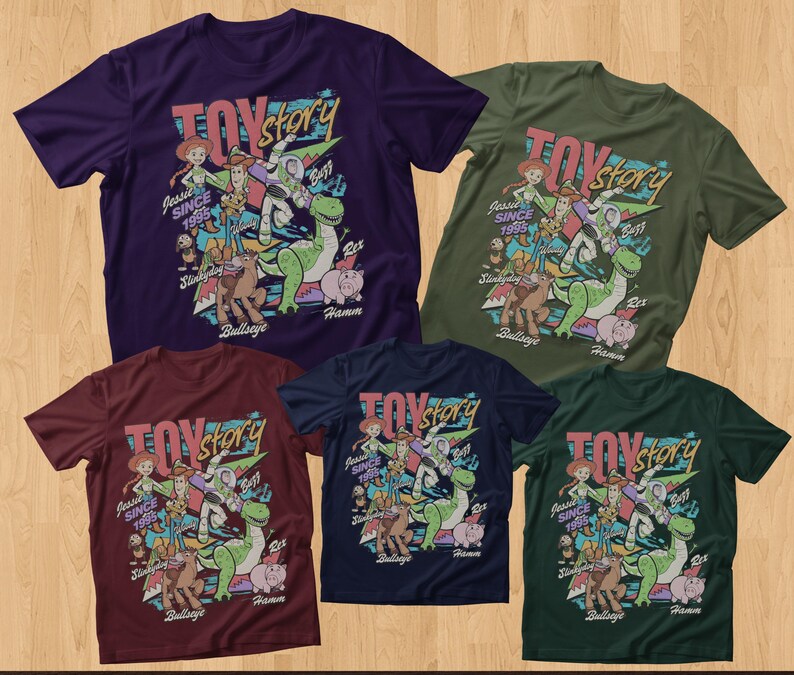 May include: Five short-sleeve t-shirts in purple, olive green, maroon, navy blue, and dark green. Each shirt features a graphic print of Toy Story characters including Jessie, Woody, Buzz Lightyear, Rex, Slinky Dog, Bullseye, and Hamm with text.
