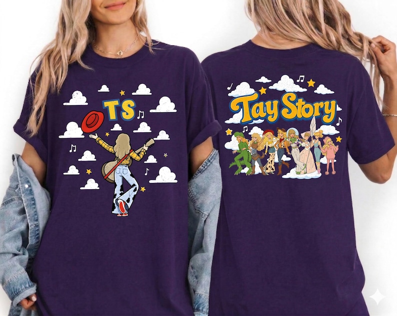 May include: A dark purple t-shirt featuring a graphic print on the front and back. The front shows a figure with a guitar, a red hat, and the text TS. The back displays a group of illustrated characters and the text Tay Story with clouds.