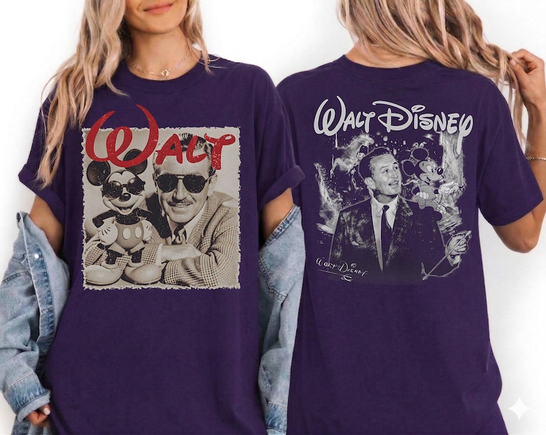 May include: A dark purple t-shirt featuring a graphic on the front of Walt Disney and Mickey Mouse wearing sunglasses with the red text WALT above them. The back of the shirt displays a black and white illustration of Walt Disney with the text WALT DISNEY.