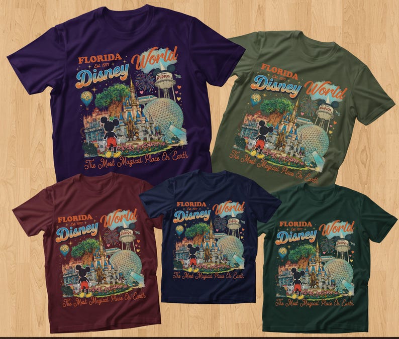 May include: Five short-sleeved t-shirts in purple, olive green, maroon, navy blue, and dark green. Each shirt features a graphic print of Florida Disney World with Mickey Mouse, the castle, and the text The Most Magical Place On Earth.