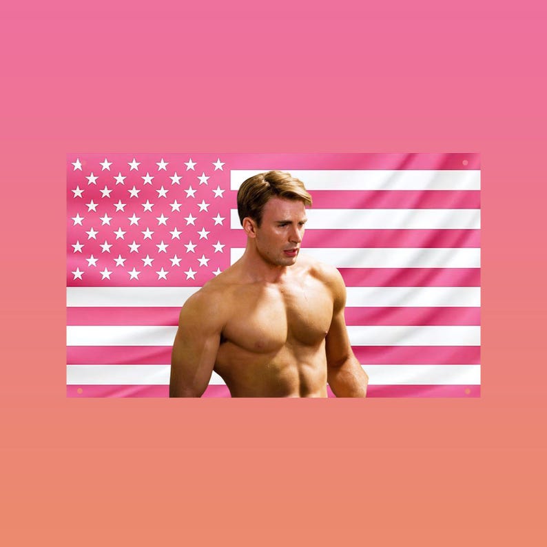 May include: A muscular person stands in front of a pink American flag. The flag has pink and white stripes and white stars in the upper left corner. The background is a gradient of pink.