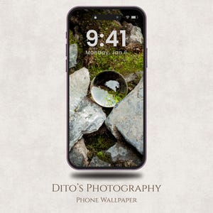May include: A smartphone displays a nature-themed wallpaper featuring a clear glass sphere resting on gray rocks and green moss. The time is 9:41 AM, Monday, Jan 6. The phone's screen is framed by a purple border. The text "DITO'S PHOTOGRAPHY PHONE WALLPAPER" is at the bottom.