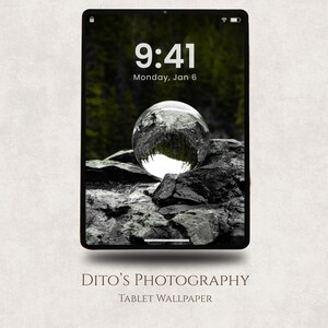 May include: Tablet wallpaper showing a clear glass sphere on dark grey rocks, reflecting a forest. The screen displays the time 9:41 and the date Monday, Jan 6. The text "DITO'S PHOTOGRAPHY" and "TABLET WALLPAPER" are at the bottom.