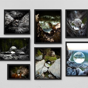 May include: Six framed art prints showcasing glass spheres in natural environments. The spheres are set against rocks, moss, and wood, with a focus on nature and reflection. The frames are black, creating a striking contrast.