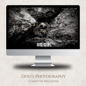 May include: A silver desktop computer showing a black and white image of rocks and a glass sphere. The screen displays the date and time. The text "Dito's Photography" and "Computer Wallpaper" is at the bottom. The background is off-white.