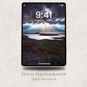 May include: A tablet displaying a scenic landscape wallpaper with a dramatic sky and sun rays over a body of water. The time displayed is 9:41 AM, Monday, Jan 6. The text "DITO'S PHOTOGRAPHY" and "TABLET WALLPAPER" are at the bottom.