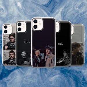 May include: A collection of clear phone cases featuring images of two men, with text that reads "bitch" and "Jerk." One case shows a mugshot with the text "LITTLE ROCK CITY POLICE." The cases are on a blue and white background.