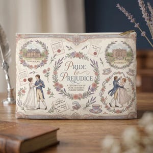 May include: A rectangular cosmetic bag with a cream background, featuring illustrations and the text "Pride & Prejudice". The design includes floral elements, architectural drawings, and a gold-colored zipper.