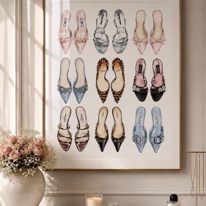 May include: A framed wall art print featuring a grid of eighteen illustrated high-heeled mules in various colors and textures, including pink, silver, leopard print, black, and blue, arranged in three rows of three pairs against a white background.