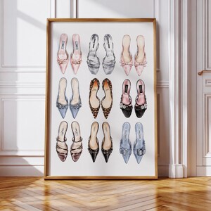 May include: A framed wall art print featuring a grid of nine pairs of illustrated high-heeled shoes in various colors and textures, including pink, silver, leopard print, black, and blue, arranged in three rows against a plain white background.