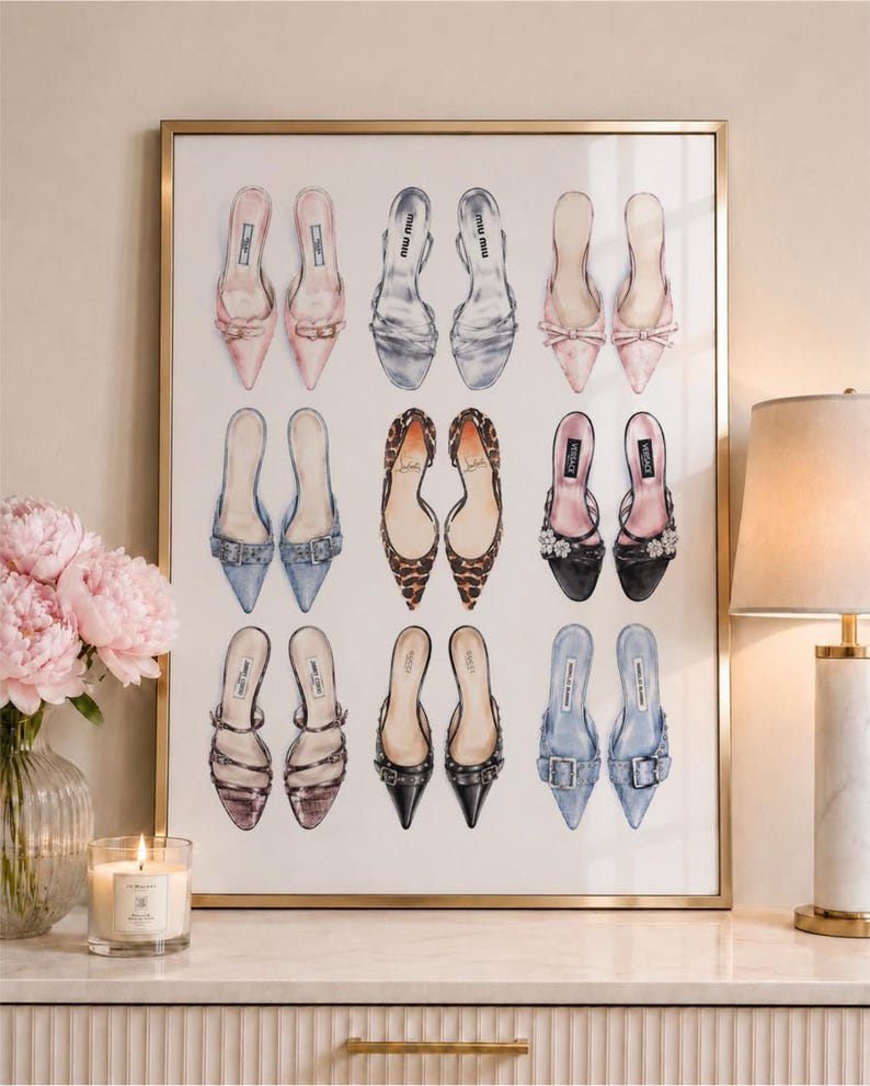 May include: A framed wall art print featuring a grid of nine pairs of illustrated high-heeled mules in various colors and textures, including pink, silver, leopard print, black, and blue, displayed against a plain white background.