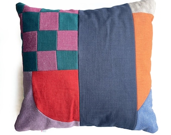Checkerboard patterned patchwork cushion mauve and red arc