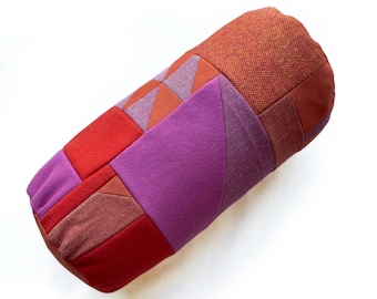 Pinks and oranges patchwork bolster cushion
