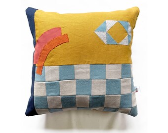 Checkerboard patchwork & appliqué patterned cushion in yellow, blue and cream