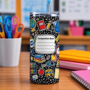 May include: A cylindrical stainless steel tumbler with a black and white speckled composition notebook pattern. The design features colorful school supply icons including a globe, books, crayons, a bus, and a label reading Composition Book.