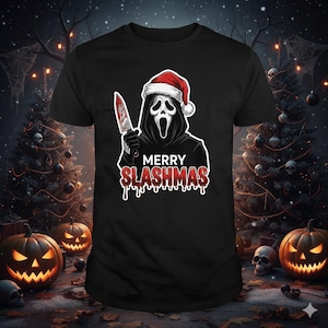 May include: Black t-shirt with a graphic of a ghost-faced figure in a Santa hat, holding a bloody knife. The text "MERRY SLASHMAS" is in red with a dripping blood effect. The design is set against a Halloween background with pumpkins and Christmas trees.