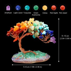 May include: A decorative tree sculpture made of copper wire and colorful gemstones. The tree is 9-10 inches tall and 2-2.36 inches wide. Gemstones include amethyst, lapis lazuli, turquoise, green aventurine, citrine, red agate, and red jasper.