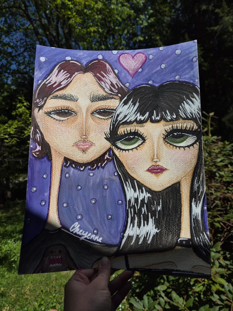 May include: A hand-drawn portrait of two figures with exaggerated features. The artwork features a purple background with white polka dots and a pink heart. The artist's name, "Cheyenne," is written on the artwork.
