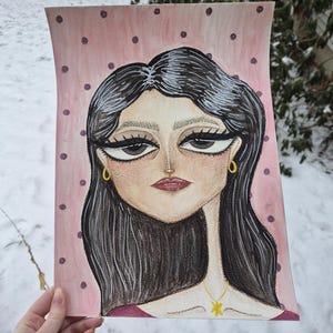 May include: A watercolor portrait of a woman with dark hair, large eyes, and a red lip. The background is pink with dark purple polka dots. The woman is wearing gold earrings and a gold pendant necklace.