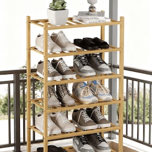 May include: A multi-tiered, light-brown bamboo shoe rack filled with various shoes. The rack holds sneakers, sandals, and other footwear. A small succulent in a white pot and decorative items sit on the top shelf. The brand name "ZenvoroCo" is visible.