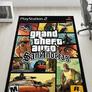 May include: A rectangular area rug featuring the Grand Theft Auto San Andreas video game cover art. The design includes a collage of game characters, a helicopter, a red tram, and the game title in white text, with the PlayStation 2 and M rating logos.