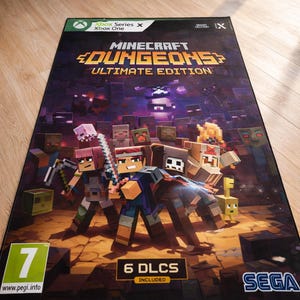May include: A rectangular Minecraft Dungeons Ultimate Edition video game case for Xbox Series X and Xbox One. The cover features blocky characters and monsters, a PEGI 7 rating, a 6 DLCs included badge, and a Sega logo on a dark background.