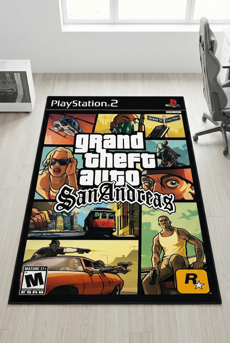 May include: A rectangular area rug featuring the Grand Theft Auto San Andreas video game cover art. The design includes a collage of game characters, a helicopter, a red tram, and the game title in white text, with the PlayStation 2 and M rating logos.
