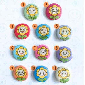 May include: A collection of eleven round button pins featuring a cartoon flower design with various facial expressions. The pins are set against a white background, with the text "BUTTON PINS" and "YOUR BEST NIGHTMARE" visible.