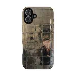 May include: A smartphone case with a reflective, mosaic-like design. The case has a grid pattern of small, square tiles in shades of silver and grey. The camera lenses are visible at the top.