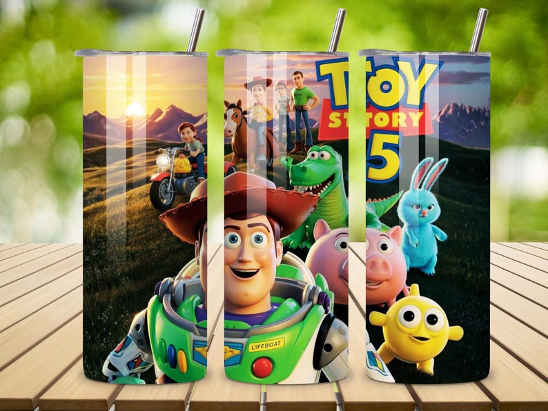 May include: A cylindrical tumbler featuring a Toy Story 5 graphic print. The design displays characters including Woody, Buzz Lightyear, Rex, Hamm, and Ducky and Bunny against a sunset landscape. The text Toy Story 5 is visible in bold yellow letters.