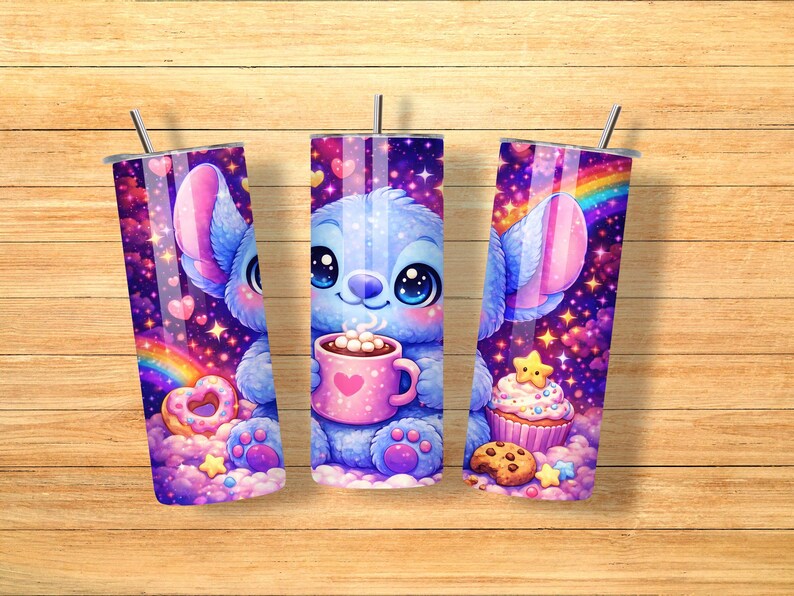 May include: Three stainless steel tumblers with a cartoon character design. The design features a blue creature holding a pink mug with a heart, a rainbow, and a cupcake. The tumblers are decorated with hearts, stars, and a galaxy background.