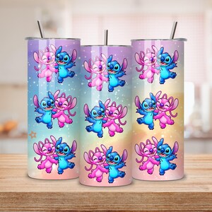 May include: Three stainless steel tumblers with a colorful design featuring the characters Stitch and Angel from Lilo & Stitch. The tumblers have a gradient background of blue, pink, and yellow. Each tumbler has a silver straw.