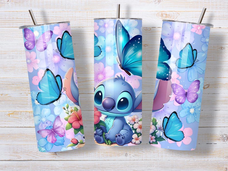 May include: A cylindrical stainless steel tumbler featuring a light blue background with a repeating pattern of blue and purple butterflies, pink and white flowers, and a central illustration of a blue alien character holding a pink flower.
