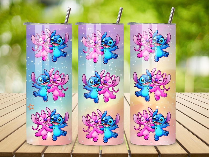 May include: Three stainless steel tumblers with a cartoon design of a blue and pink alien couple. The tumblers have a gradient background of pink, blue, and yellow. Each tumbler has a silver straw.