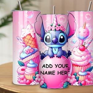 May include: Pink insulated tumbler featuring a cartoon character with a unicorn horn, surrounded by cupcakes, ice cream cones, and bubbles. The tumbler has a silver straw and the text "ADD YOUR NAME HERE" on a pink bubble.