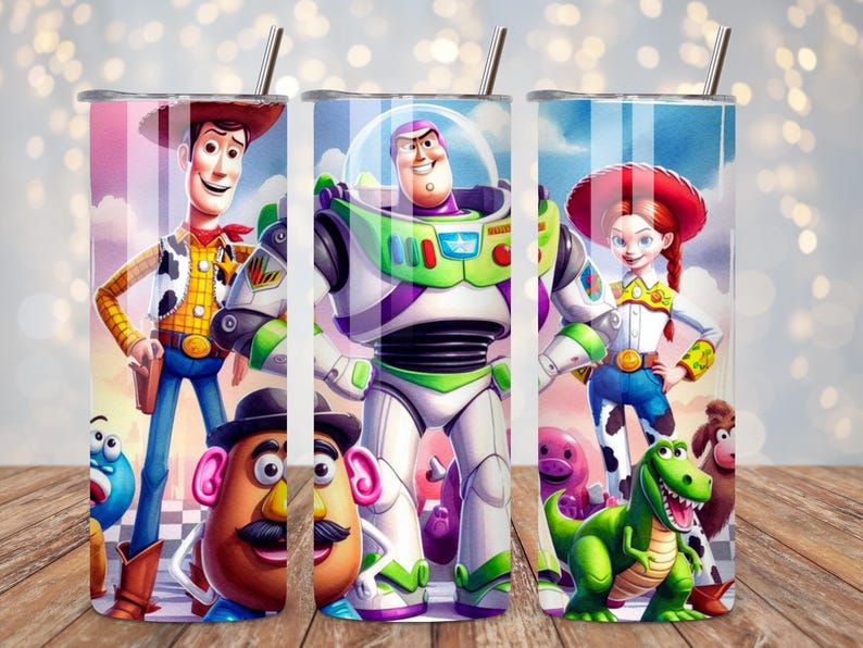 May include: A cylindrical stainless steel tumbler featuring a colorful wrap-around graphic of animated characters including a cowboy, a space ranger, a cowgirl, a potato-shaped figure, and a green dinosaur, topped with a thin metal straw.