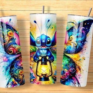May include: Three white insulated tumblers with a colorful butterfly and Stitch design. The design features a blue Stitch character holding a lantern, set against a vibrant watercolor background with splashes of blue, yellow, pink, and green.