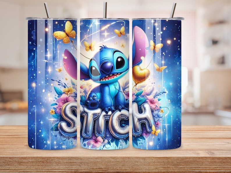 May include: A blue tumbler featuring the character Stitch from Lilo & Stitch. The design includes butterflies, flowers, and the word "Stitch" in silver letters. The background is a gradient of blues with sparkling effects, and the tumbler has a silver lid and straw.